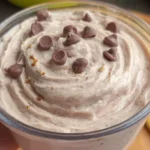 Ninja Creami chocolate mousse topped with chocolate chips, served with a crunchy biscuit