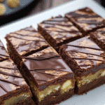 Slices of fudgy Dubai chocolate brownies topped with ganache and filled with white chocolate chunks