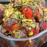 Chocolate-covered strawberries topped with crushed pistachios in Dubai dessert box