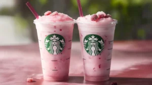 Iced Starbucks pink drink with freeze-dried strawberries in clear plastic cup