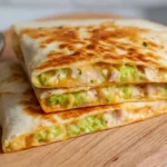 Avocado Cottage Cheese Quesadilla served with dip on wooden board