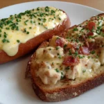Two slices of toast topped with creamy chipped beef sauce and chives, classic Shit on a Shingle dish