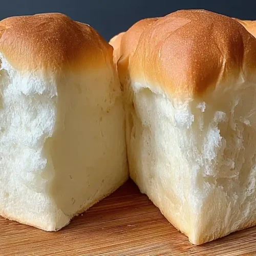 Cloud Toast Bread: The Fluffy TikTok Trend Every Student Needs to Try 4 Fluffy homemade Cloud Toast Bread loaf with golden brown crust and soft airy texture on a wooden board.