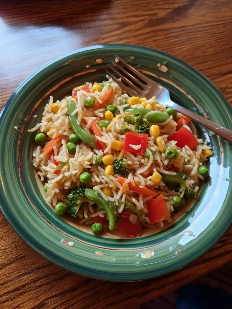 5 Cheap Microwave Meals Under 10 Minutes for College Students 5 Microwave fried rice with colorful vegetables and soy sauce served in a bowl.