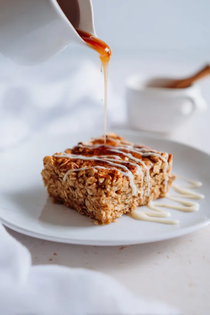 5 Cozy December Recipes Loved Across the USA (No Holiday Needed) 4 Maple cinnamon oatmeal bake on a white plate under soft natural light.