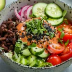 Vegetarian Burger Bowl Recipe (Cheap & Easy Meal) Vegetarian burger bowl with beans, lettuce, tomatoes, cucumbers, and vegan sauce.