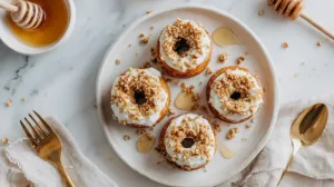 Caramelized donut peaches on a white plate with honey and yogurt — easy summer dessert for students.