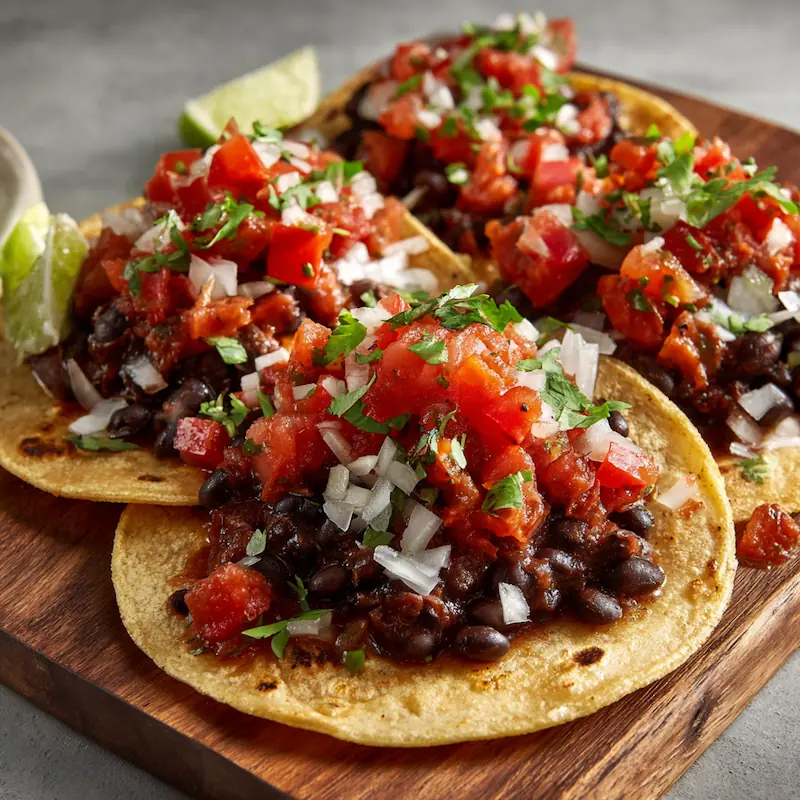 Easy Recipes for Beginners with Few Ingredients (Student-Approved & Budget-Friendly) 5 Three black bean tacos topped with chunky salsa on warm tortillas