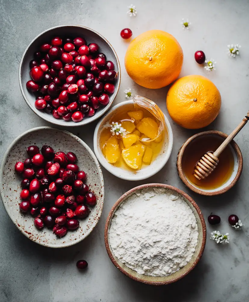 Healthy Cranberry Orange Bread (Student Budget-Friendly Recipe) 3 Ingredients for healthy cranberry orange bread neatly arranged on a kitchen counter — cranberries, oranges, honey, and flour