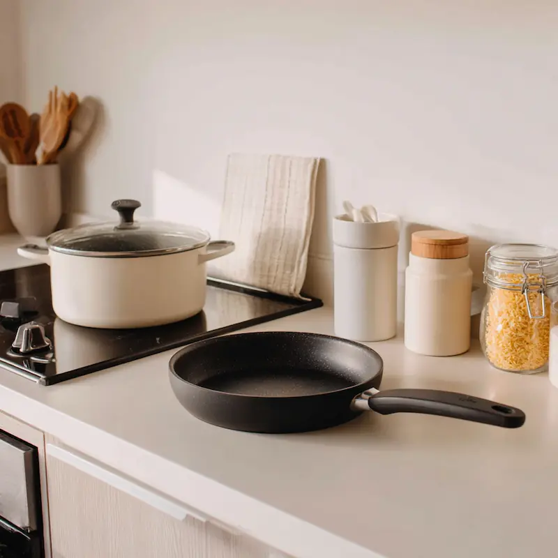 Easy Recipes for Beginners with Few Ingredients (Student-Approved & Budget-Friendly) 2 Minimalist student setup with a pot, a skillet, and three pantry ingredients on a small counter