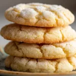 Stack of soft, chewy sugar cookies with crackly sugared tops on a small plate