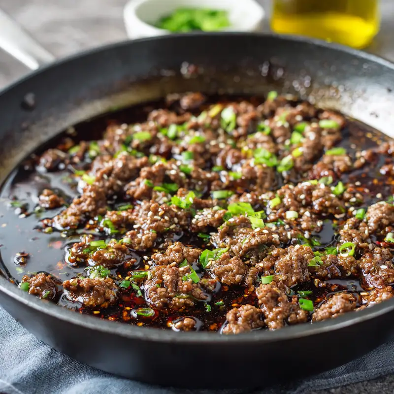 ✨ Easy Korean Ground Beef Bowl — Cheap, Quick & Addictive (Student Edition) 3 Ground beef sizzling in a skillet with soy-garlic glaze for an easy Korean Ground Beef Bowl