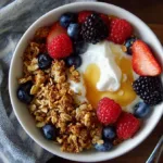A creamy high-protein cottage cheese breakfast bowl topped with fresh berries, honey drizzle, and crunchy granola on a dorm desk.