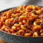 Authentic American goulash with macaroni, ground beef, and rich tomato sauce served in a rustic bowl