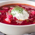Classic Ukrainian borscht soup made with beets, cabbage, and potatoes topped with sour cream
