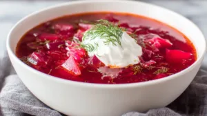 Classic Ukrainian borscht soup made with beets, cabbage, and potatoes topped with sour cream