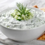Creamy homemade tzatziki sauce made with Greek yogurt, cucumber, garlic, and fresh dill served with pita chips