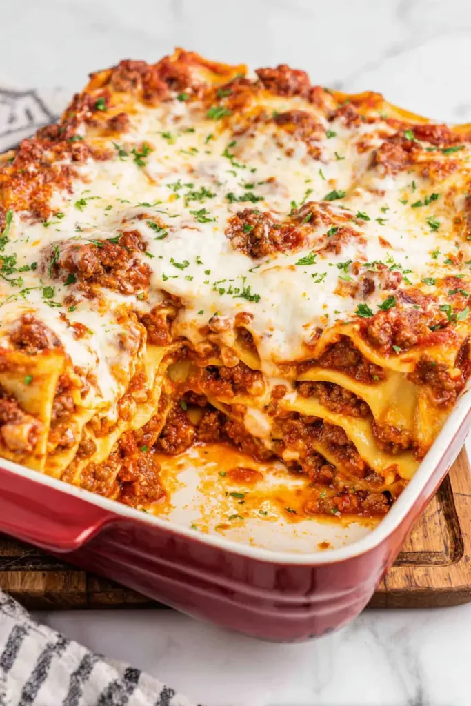 Easy Meat Lasagna Recipe Everyone Loves 2 Slice of cheesy meat lasagna with layers of pasta, meat sauce, and melted cheese