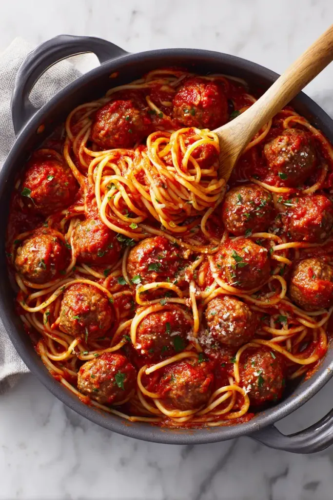 Spaghetti and meatballs served with rich tomato sauce and parmesan cheese in a bowl