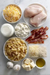 Chicken Bacon Ranch Pasta (Creamy, Easy & Family-Friendly) 5 Ingredients for chicken bacon ranch pasta including pasta, chicken breast, bacon, ranch seasoning, cheese, and cream cheese