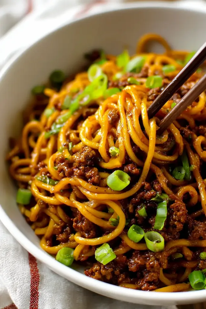 Easy Mongolian Ground Beef Noodles (Quick, Budget-Friendly Dinner) 2 Bowl of Mongolian ground beef noodles with glossy sauce and green onions