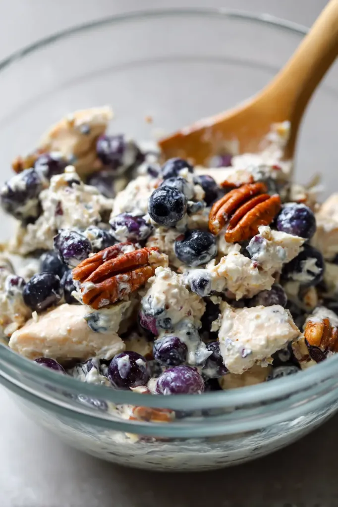 Blueberry pecan chicken salad served on a croissant with creamy chicken salad, fresh blueberries, and toasted pecans