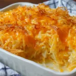 Cheesy cracker barrel hashbrown casserole baked until golden brown in a casserole dish