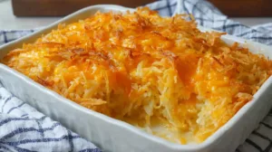 Cheesy cracker barrel hashbrown casserole baked until golden brown in a casserole dish