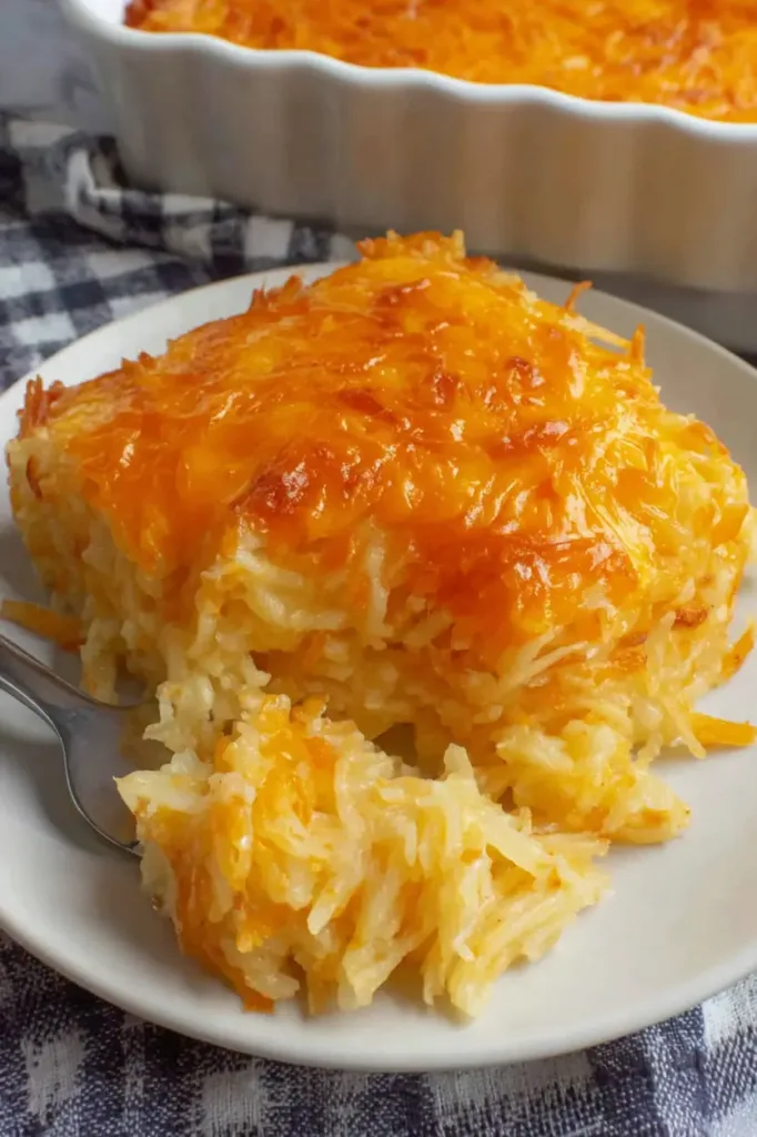 Cheesy cracker barrel hashbrown casserole baked until golden and bubbly in a casserole dish