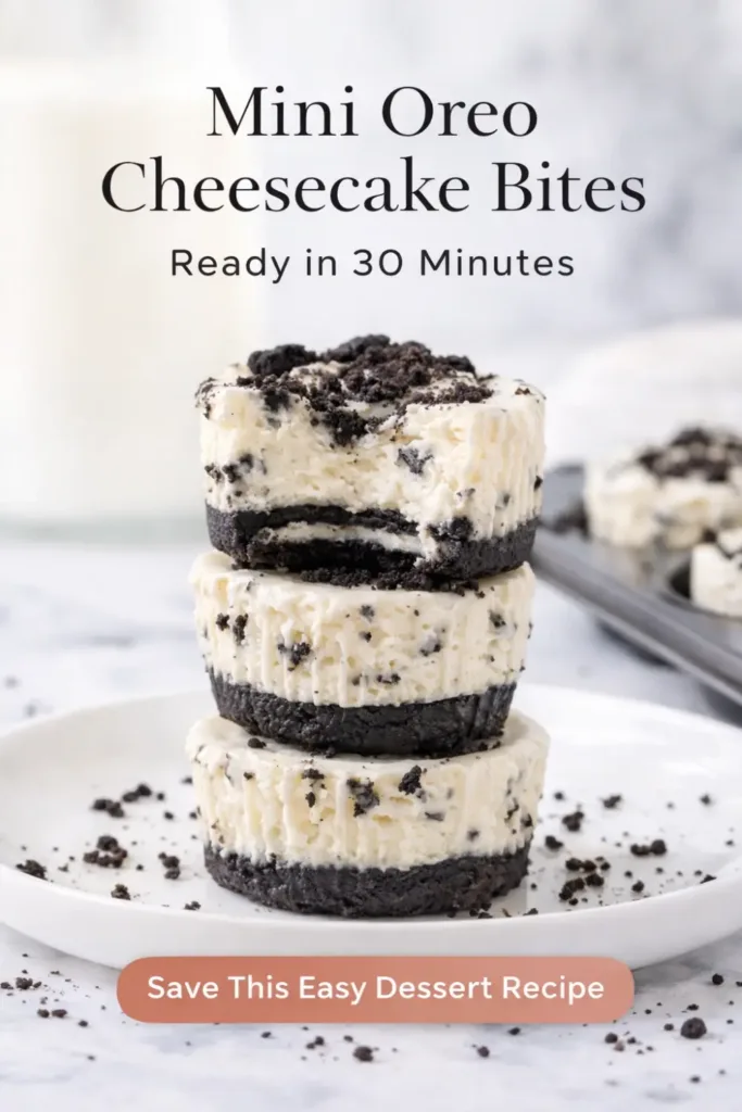 Close-up of mini Oreo cheesecake bites topped with crushed Oreos, showing creamy cheesecake texture and cookie crust.