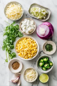 Easy Creamy Corn Salsa (Better Than Restaurant Style) 5 Ingredients for creamy corn salsa including corn kernels, sour cream, shredded cheese, lime, red onion, jalapeño, and cilantro