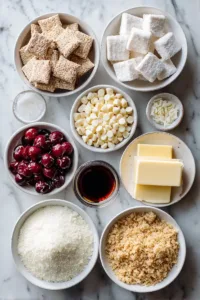 Ingredients for cherry cheesecake puppy chow including rice cereal squares, white chocolate chips, cream cheese, powdered sugar, butter, vanilla extract, and chopped cherries arranged in small bowls