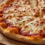 Homemade crispy chewy bubbly pizza dough with golden blistered crust and airy bubbles baked on artisan pizza.