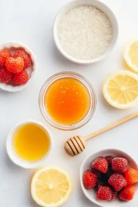 Ingredients for translucent gummy bears recipe including gelatin powder, fruit juice, honey, lemon juice, and silicone gummy bear molds.