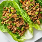 A plate of PF Chang’s chicken lettuce wraps made with ground chicken, mushrooms, and crisp lettuce leaves